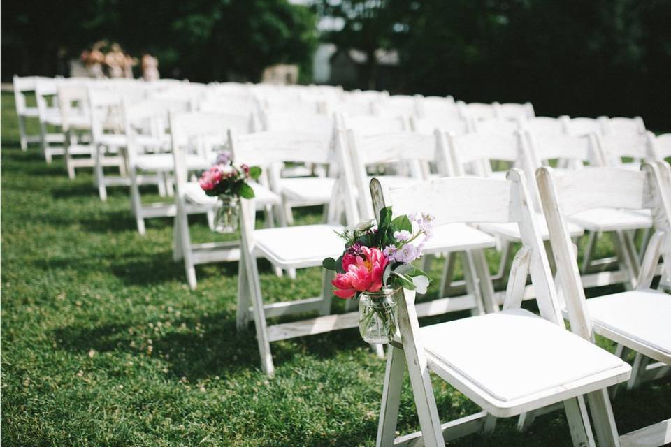 White chairs with floral accessories