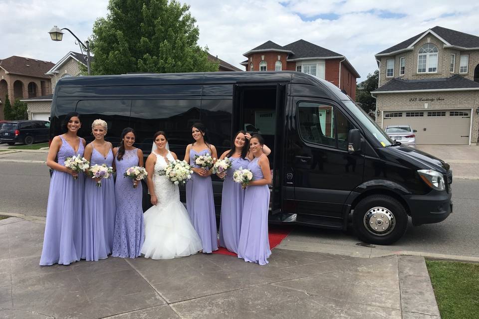 Bride and her bridesmaids by luxury vehicle