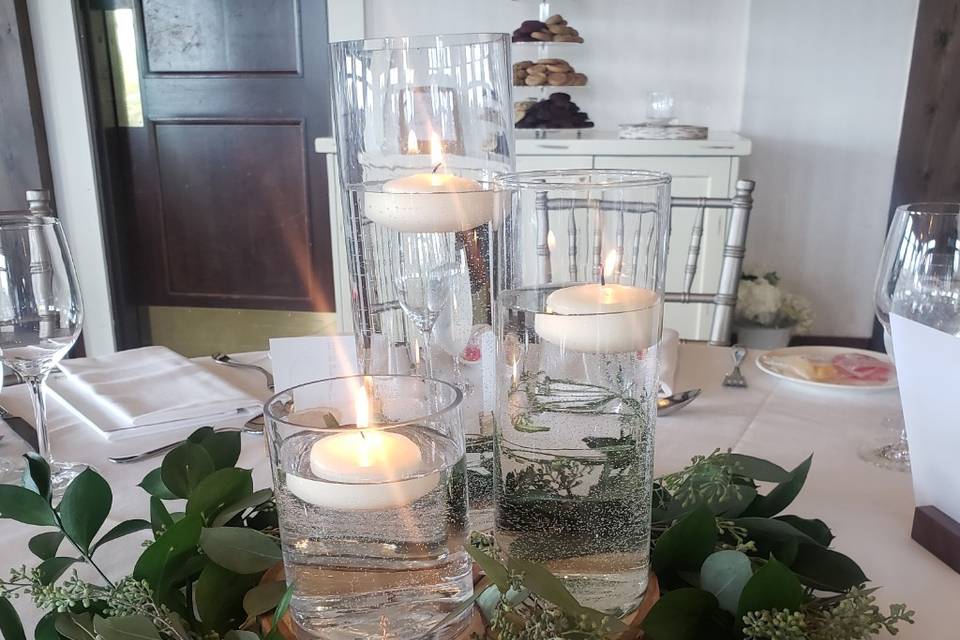 Floating candles and greenery