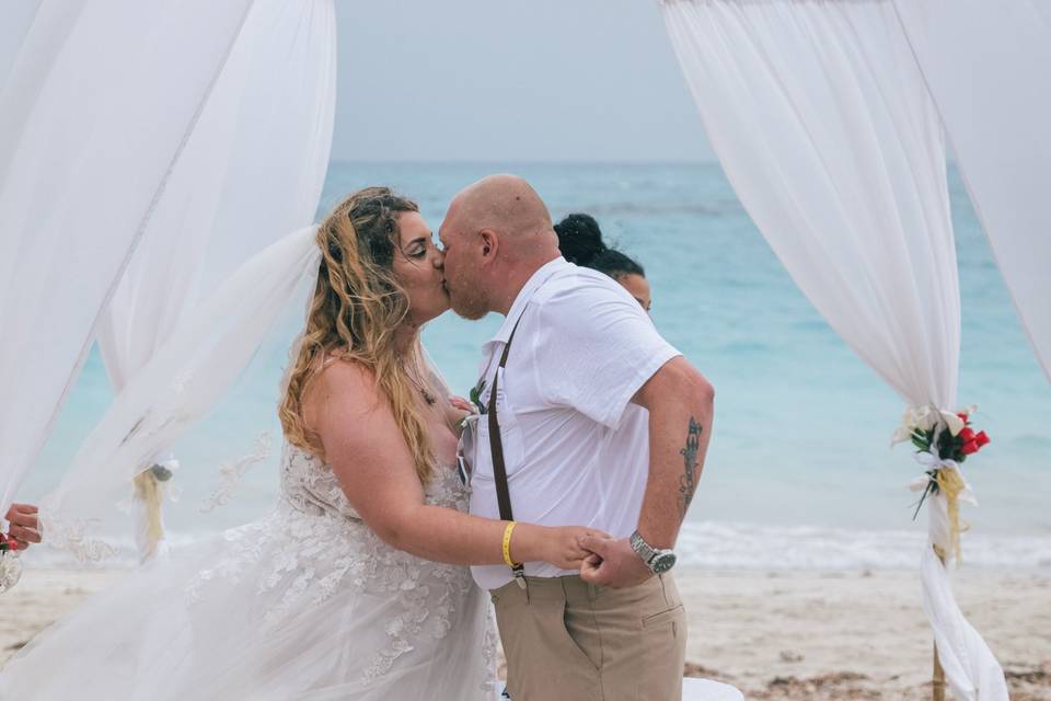 Couple kissing beach wedding