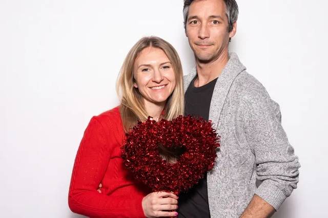 Couple at the booth with a heart prop