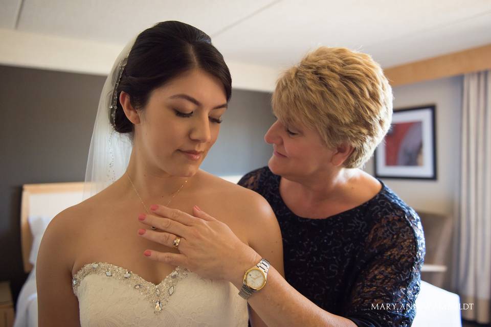 Mother helping bride