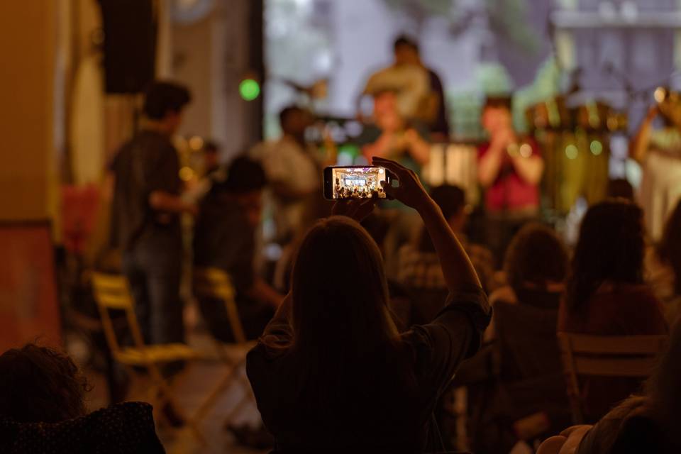 Person filming band on phone