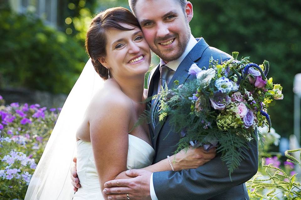 Bride & groom in wildflowers