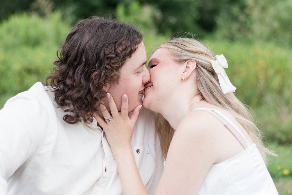 Engaged couple kissing