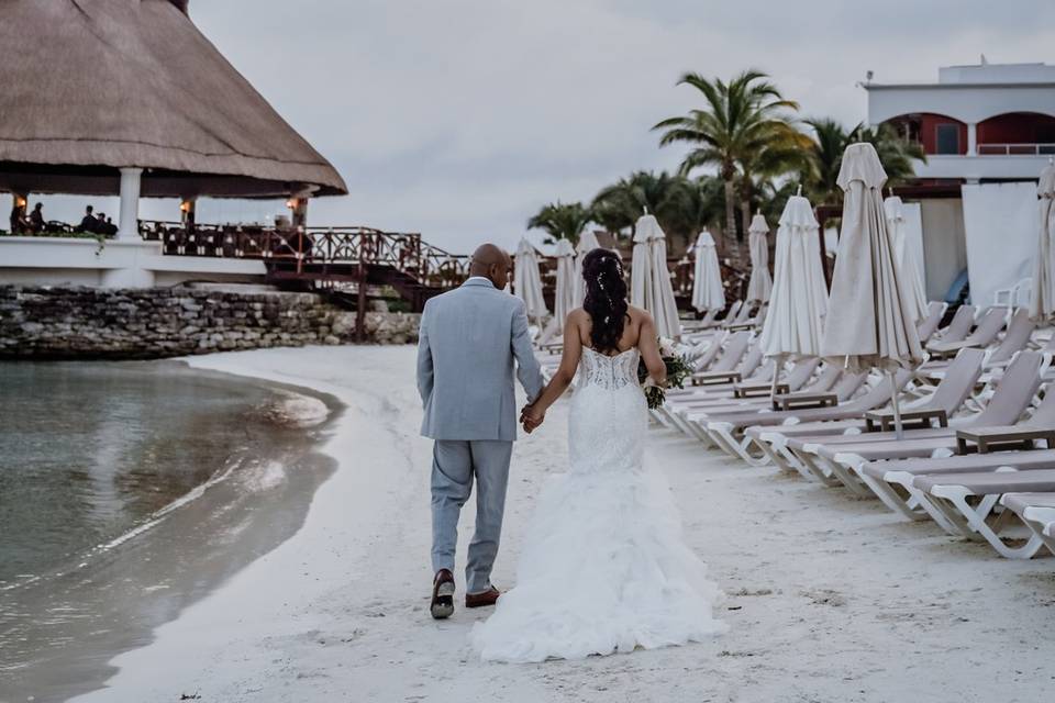 Groom wiping tears off bride.