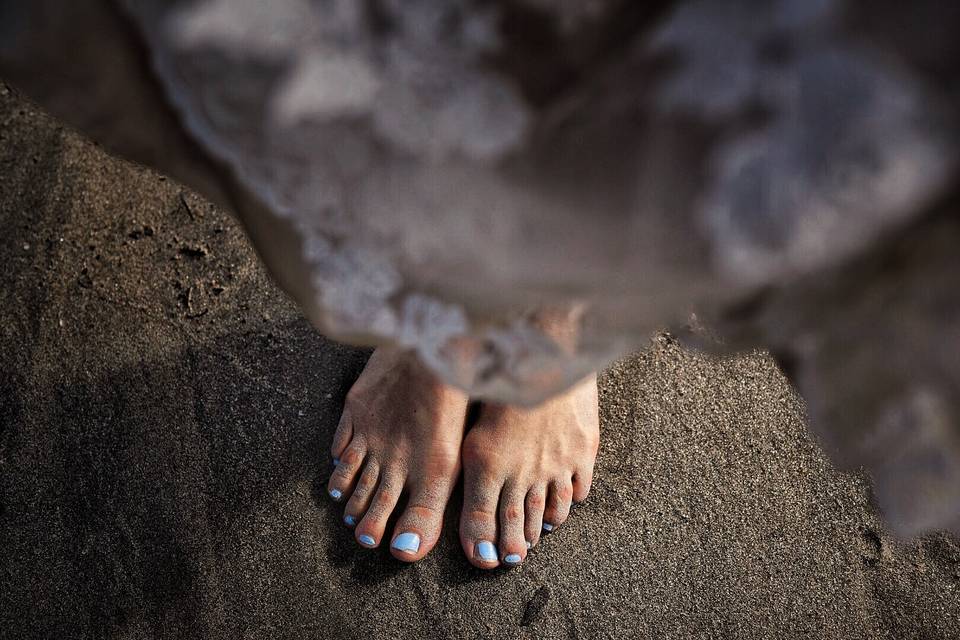 Barefoot bride in sand