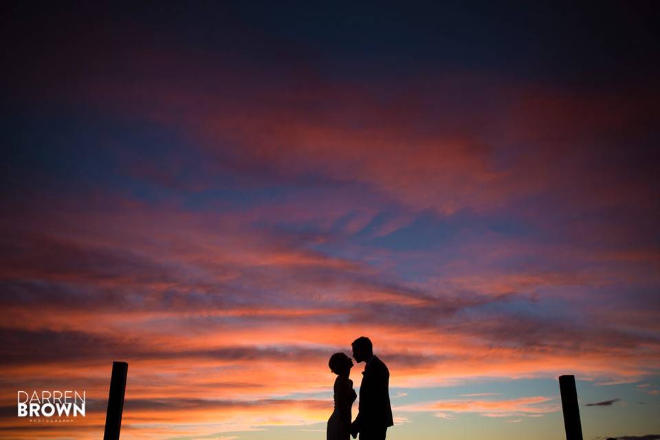 Bride and groom under sunset