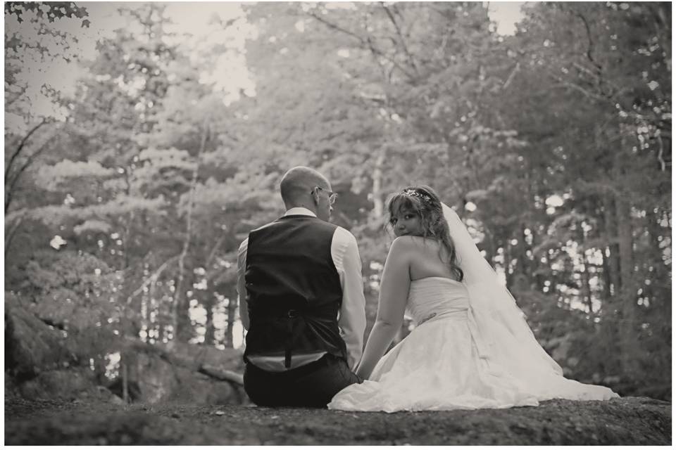 A&C, seated in woods