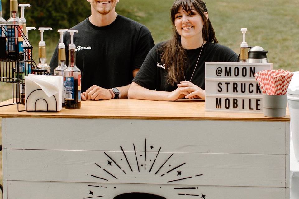 Staff at wedding with coffee cart