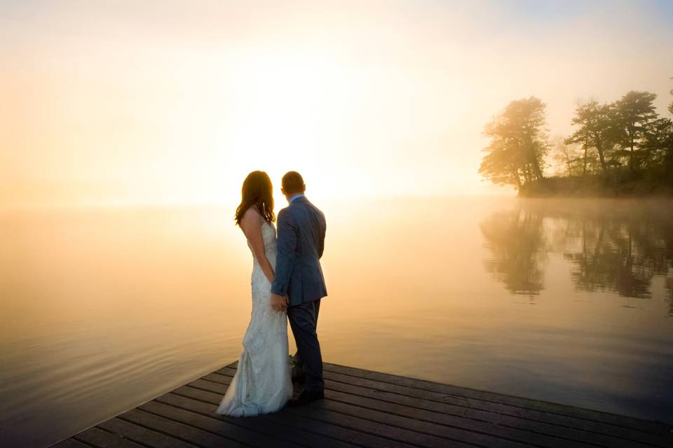 Bridal couple on dock sunset