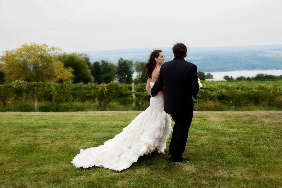 Bride & groom walk in field