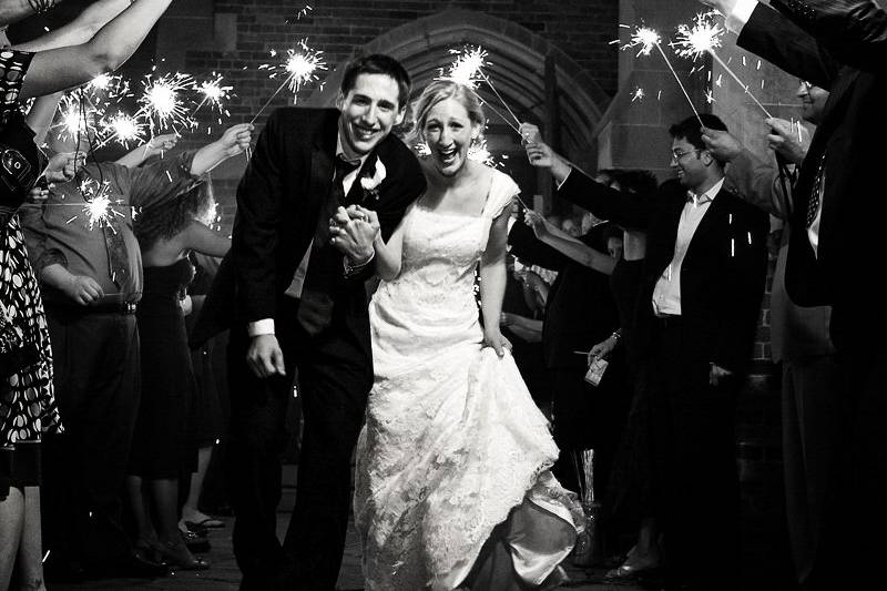 Bridal couple exit under arch