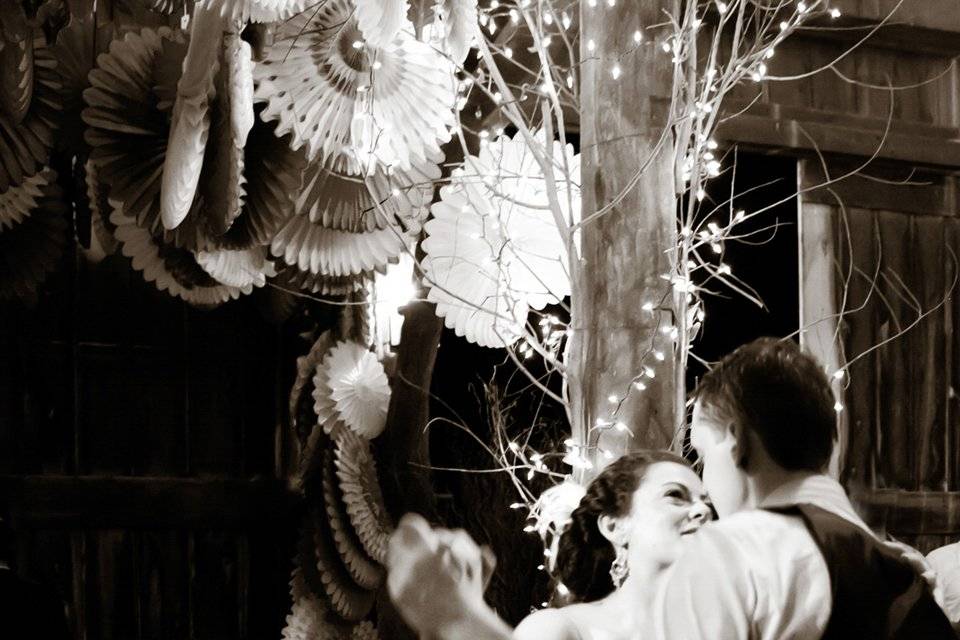 Bride and groom dance in  barn