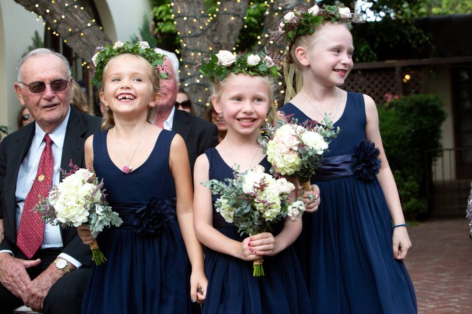 Flower girls joyfully walk dow