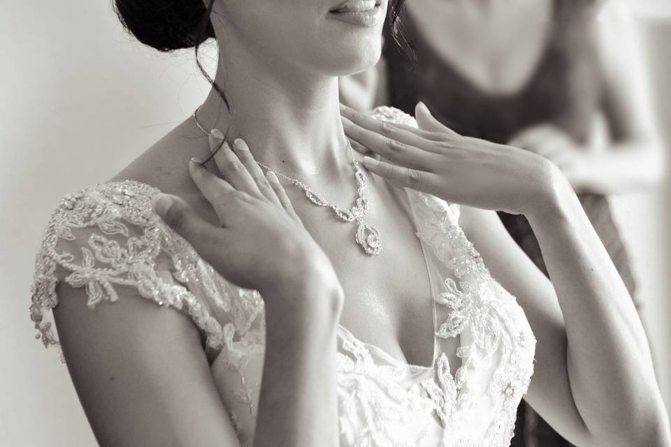 Bride inspects necklace in mir