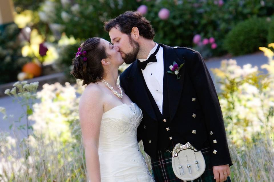 Groom with kilt embraces bride