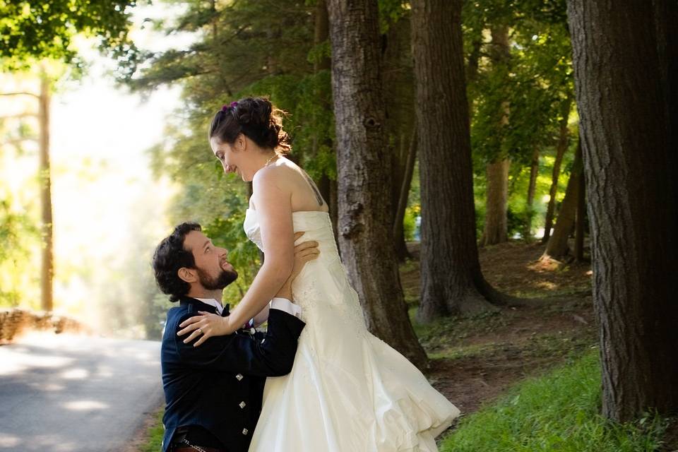 Bride and groom walk backlit w