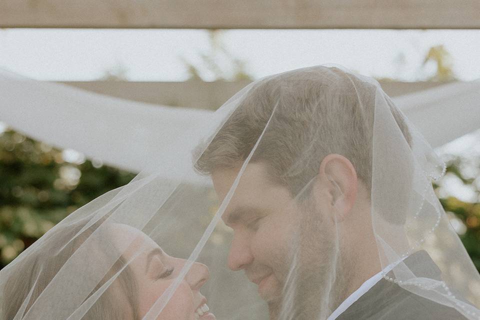 Bride and groom under the veil