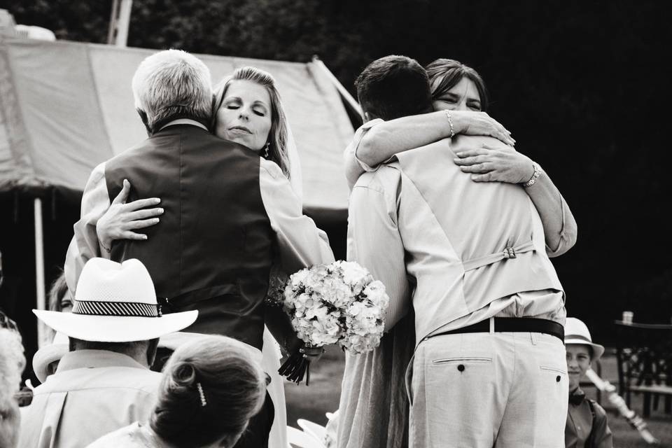 Giving the bride & groom hugs