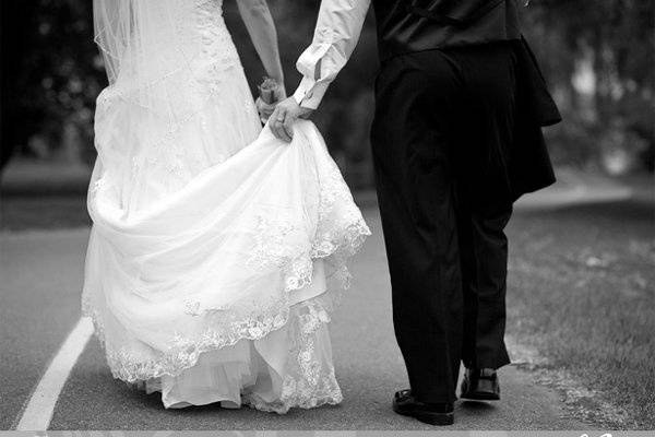 Bride and groom walking away in black and white.jpeg