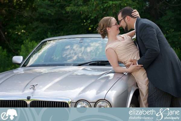 Wedding Photos? photo of the bride and groom touching noses on a Jaguar car.jpeg