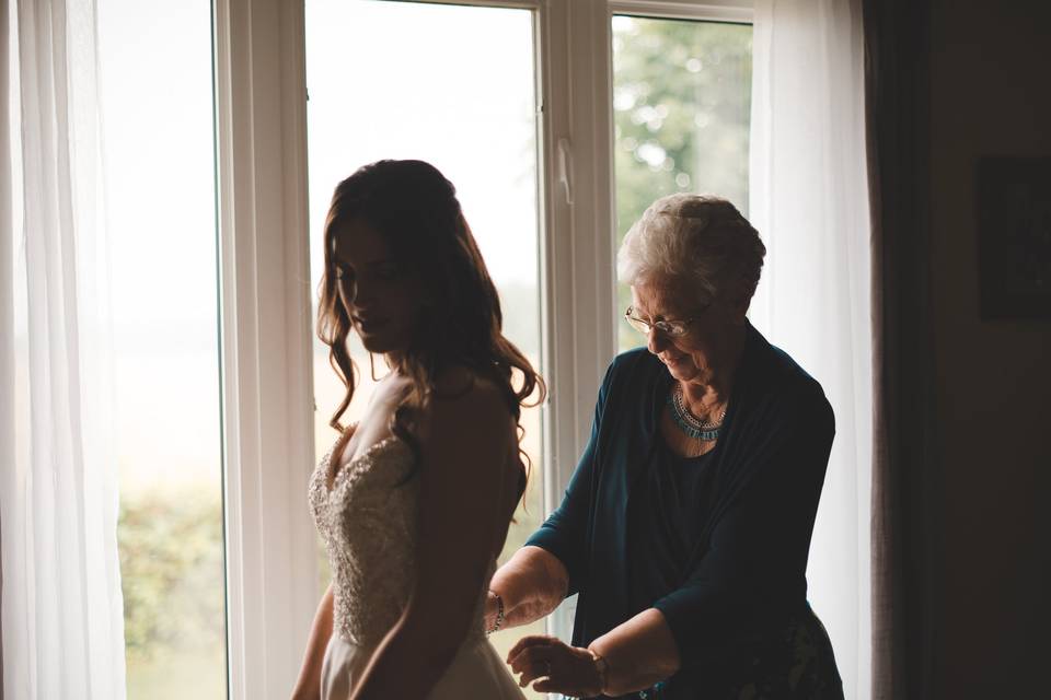 Grandmother helping bride