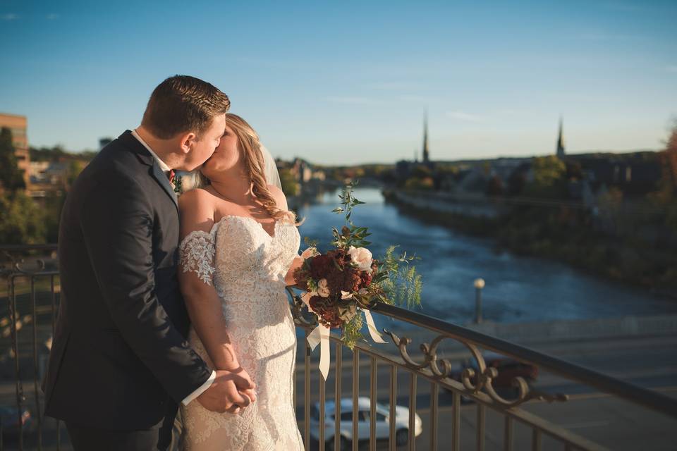 Bride & Groom kiss by river