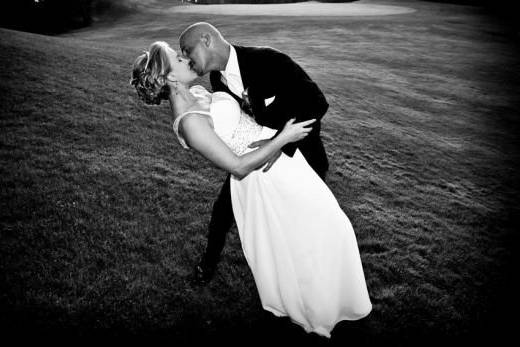 modern-groom-dipping-and-kissing-modern-bride-on-golf-course.jpg