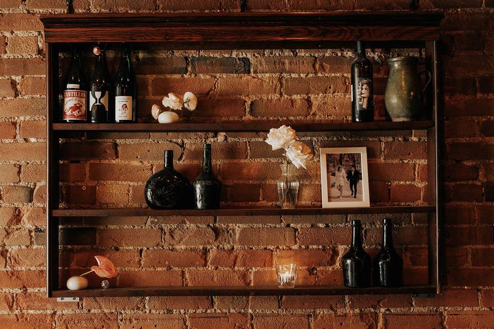 Bud vases on shelves w bottle