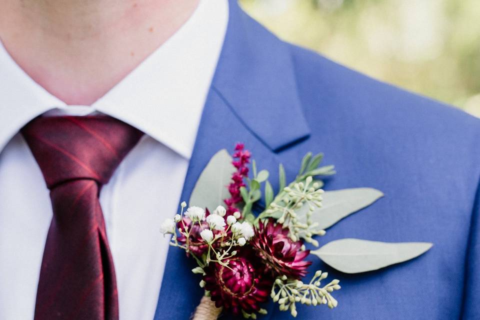 Groom's burgundy boutonniere