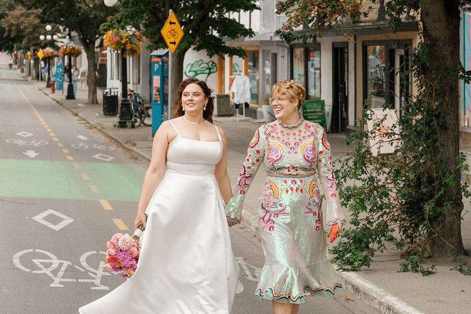 Two brides walking in city