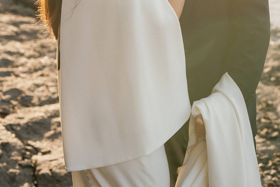 Newlyweds embracing at sunset