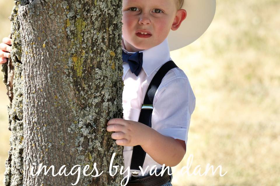 Young Cowboy behind tree