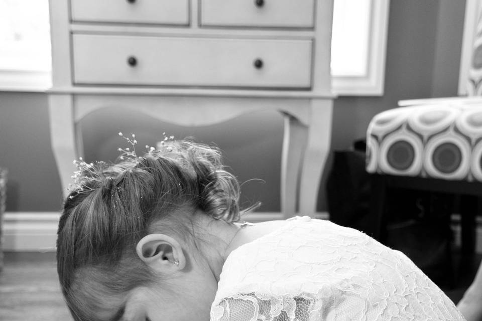 Flower girl in bride's shoes