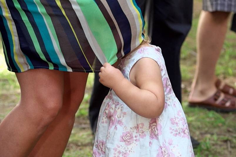 Girl Hides under Mom's Dress