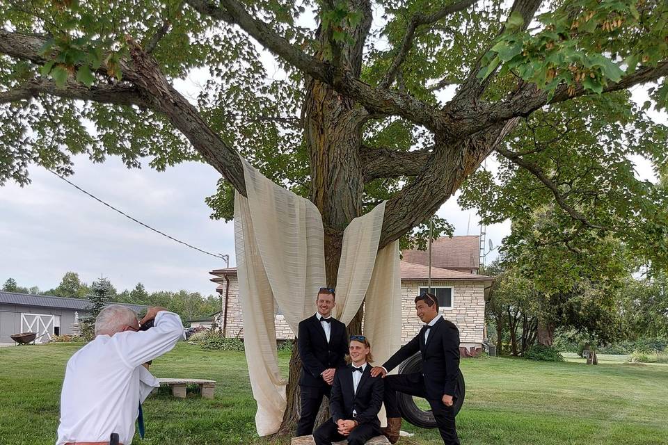 Groom men by tree