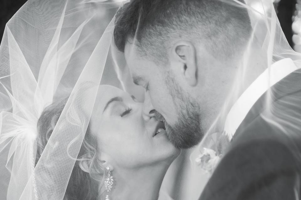 Newlyweds kiss under veil