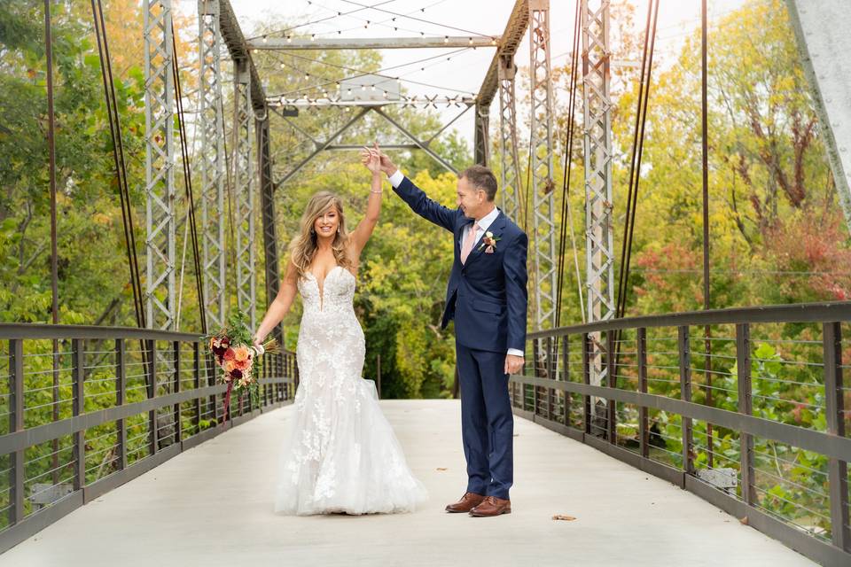 Newlyweds dance on bridge