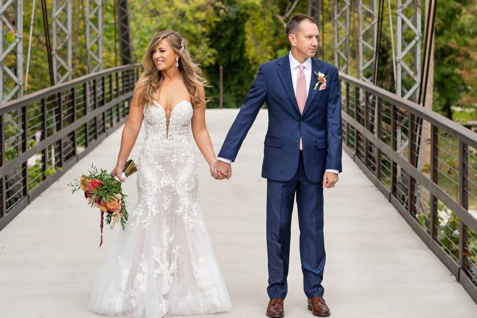 Couple hand in hand on bridge