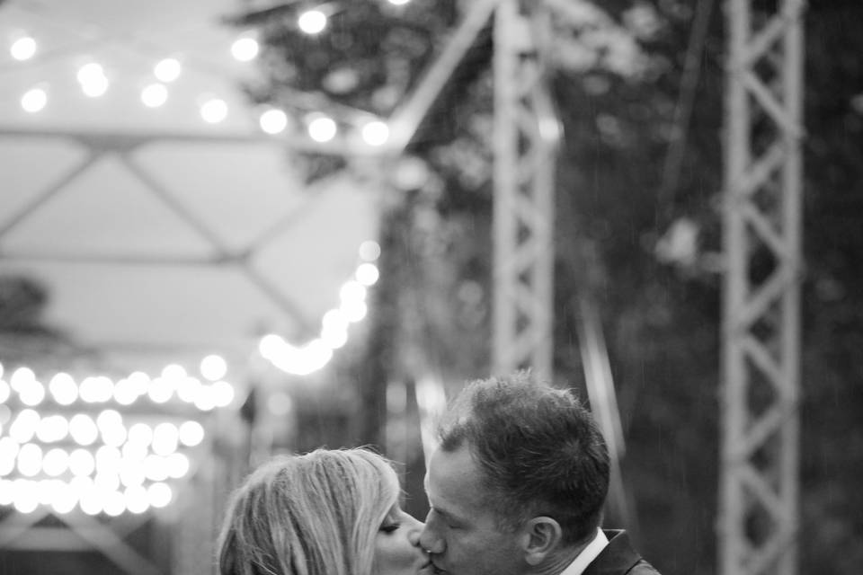 Newlyweds kiss on bridge