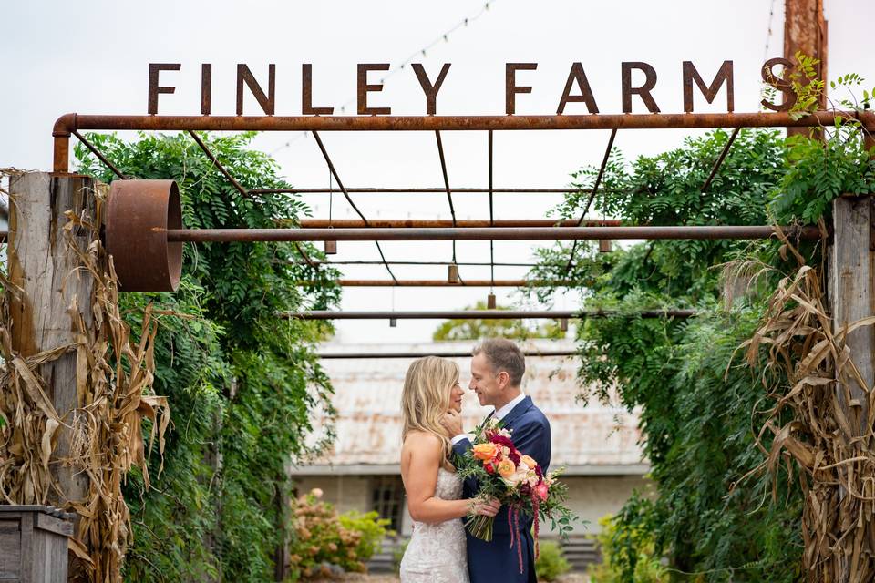 Newlyweds embrace under sign