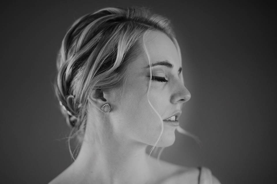 Bride putting on earrings