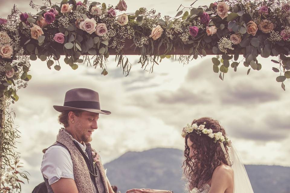 Groom putting ring on bride