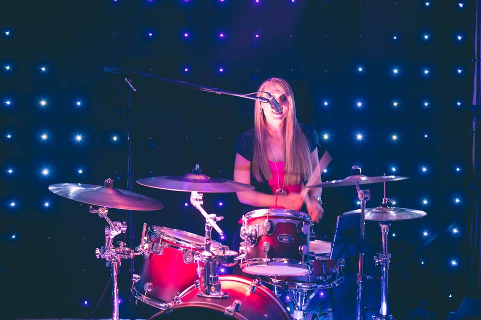 Karrie entertaining on drums