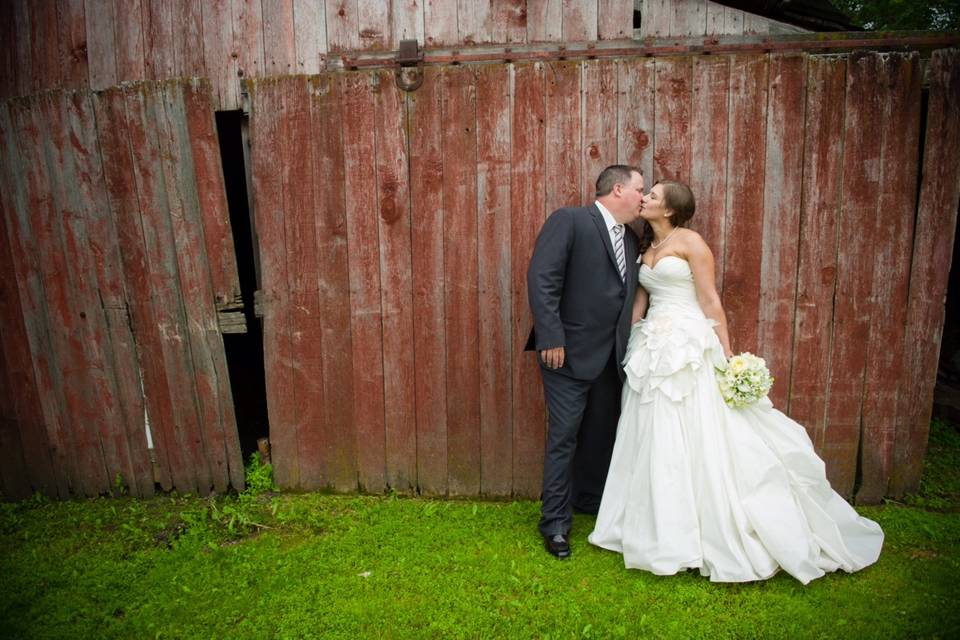 Stealing a kiss behind barn