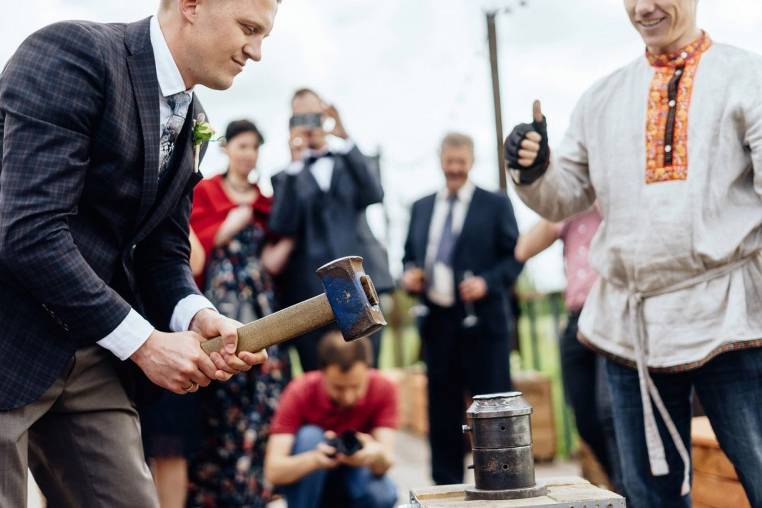 Groom striking a wedding coin