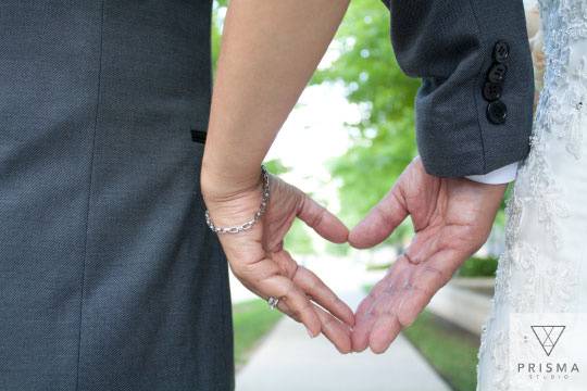 Bride and groom heart hands