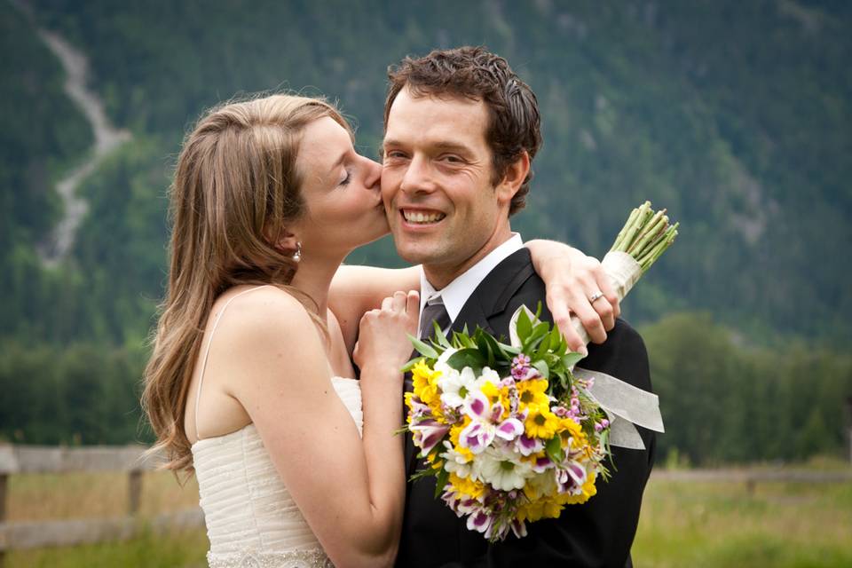 Bride kissing groom on cheek