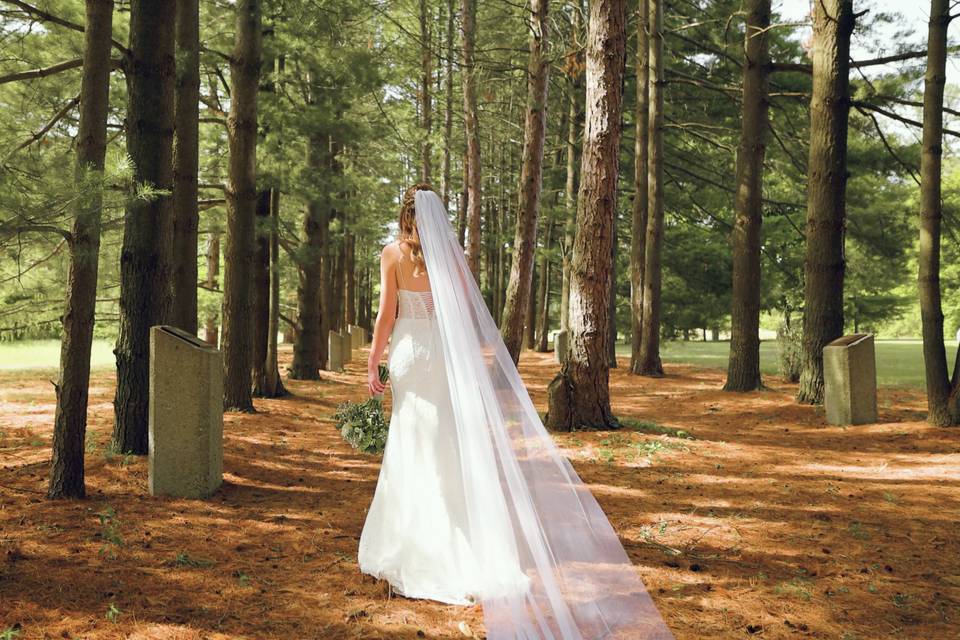 Bride walking through a forest